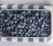 frozen blueberries on a baking sheet with a striped kitchen cloth underneath