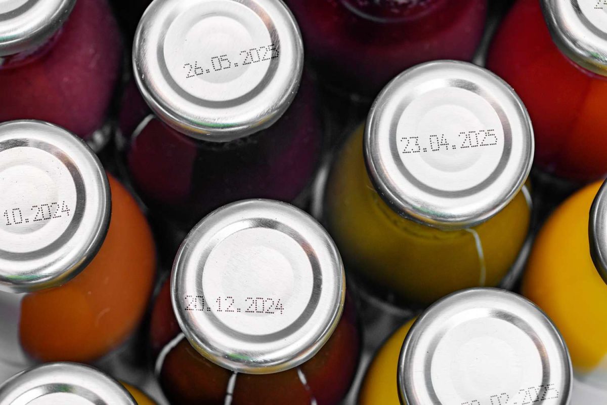 Closeup view of bottles with expiration dates printed on their caps showcasing the marked dates clearly