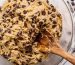 mixing chocolate chip cookie dough in glass bowl
