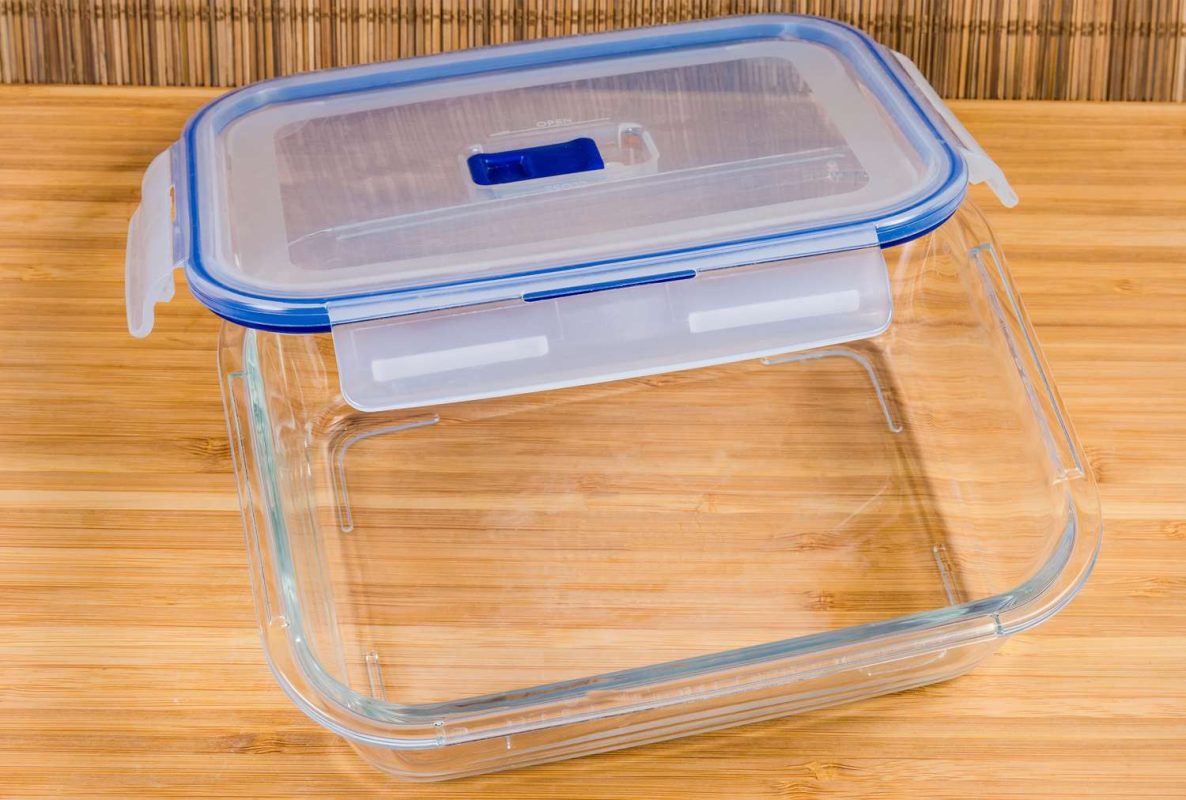 A glass food storage container with a plastic lid