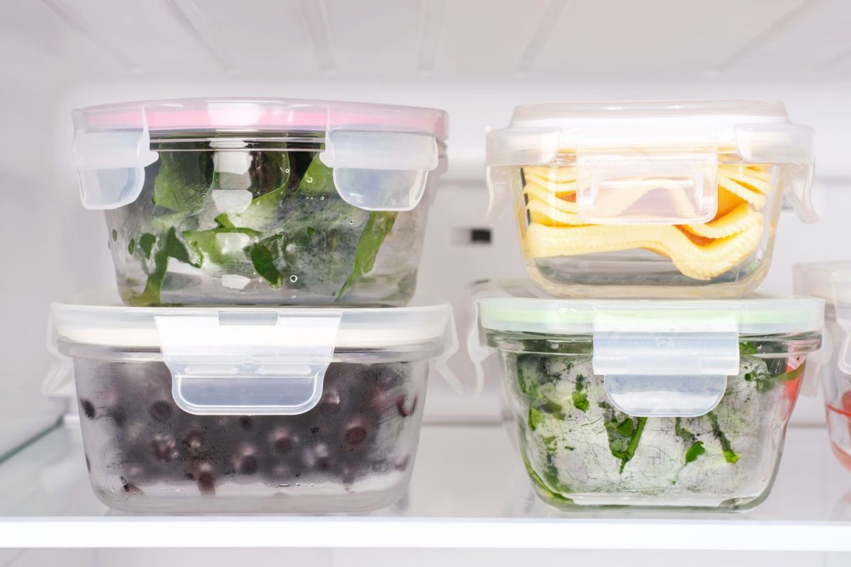 Containers with various foods stored inside a refrigerator
