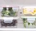 Containers with various foods stored inside a refrigerator